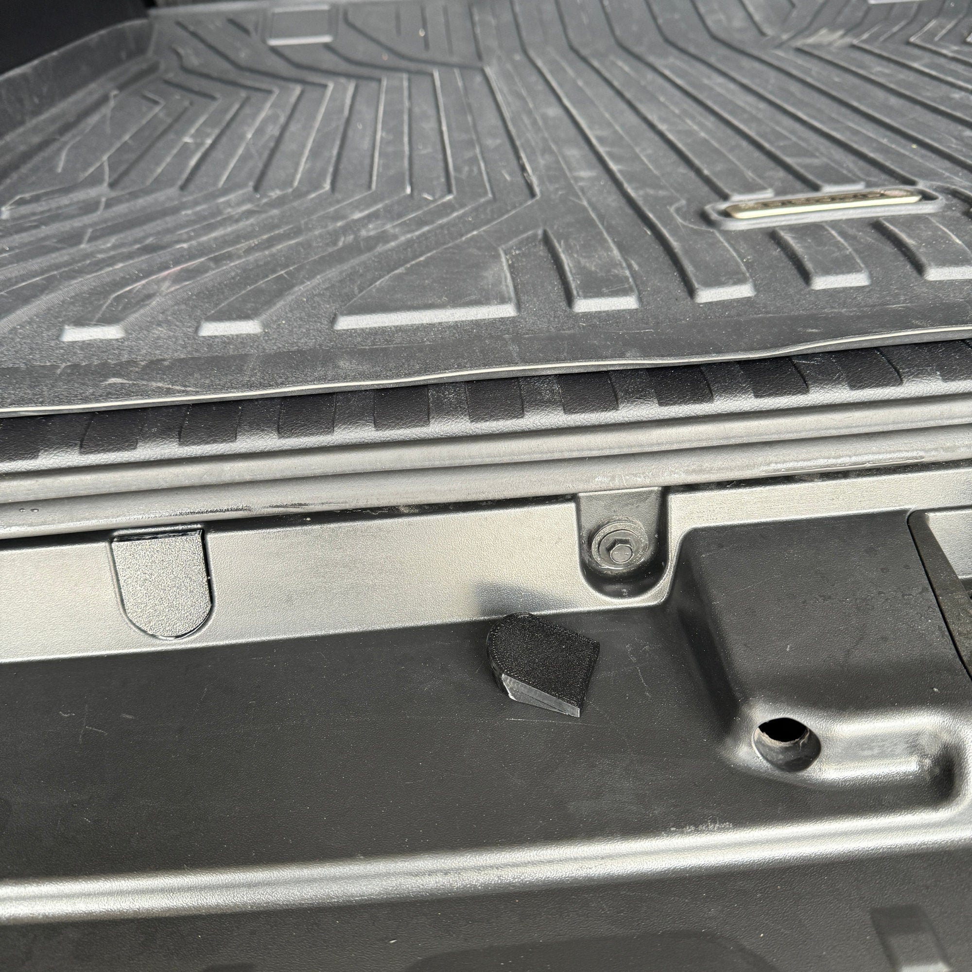 Bumper Bolt cover and bolt that it covers. Image shows the difference between a covered bolt and an exposed one