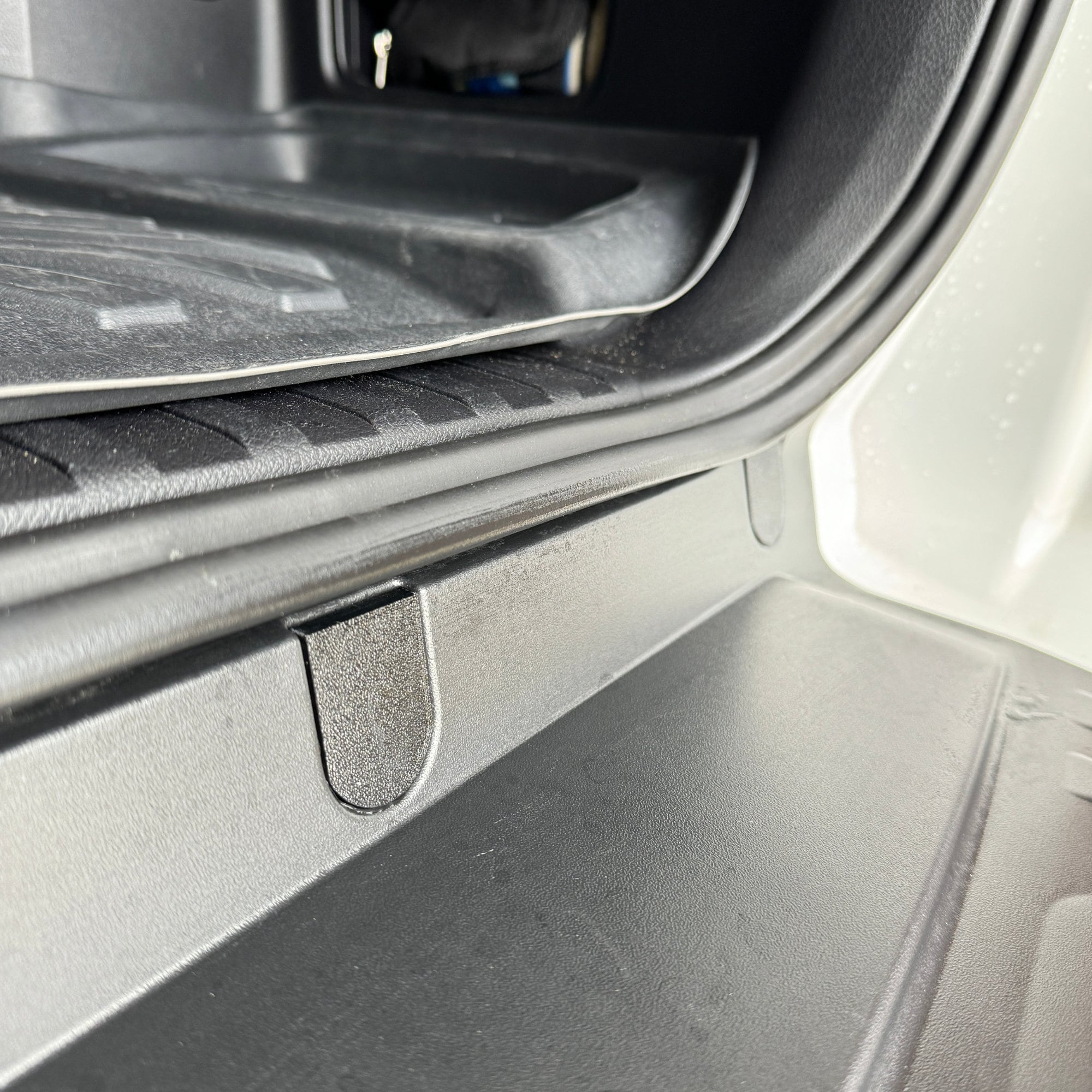 Close up of a bolt cover installed from the side view. Notice the cover fits flush to the bumper.